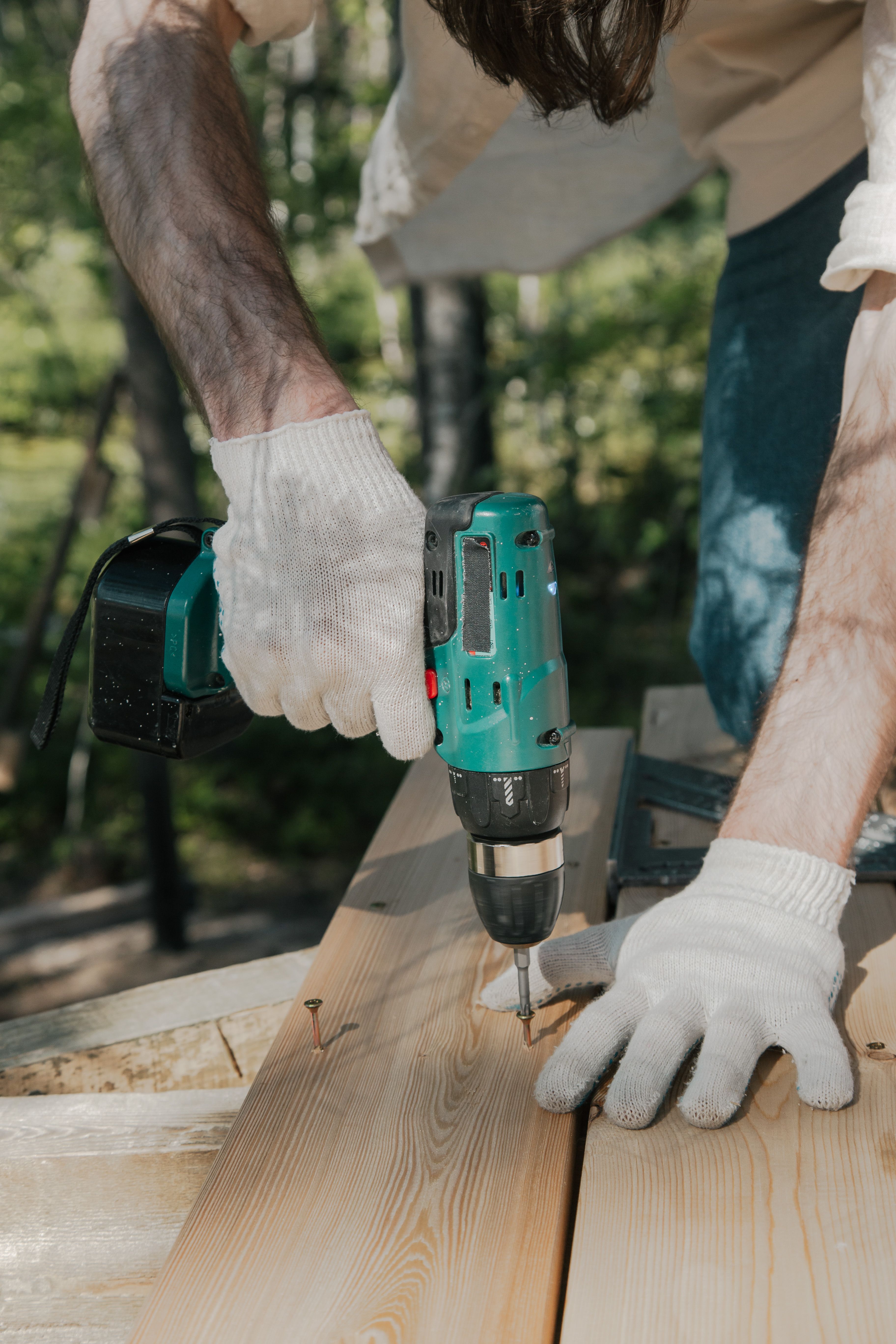 Contractor using a drill while completing skilled construction work